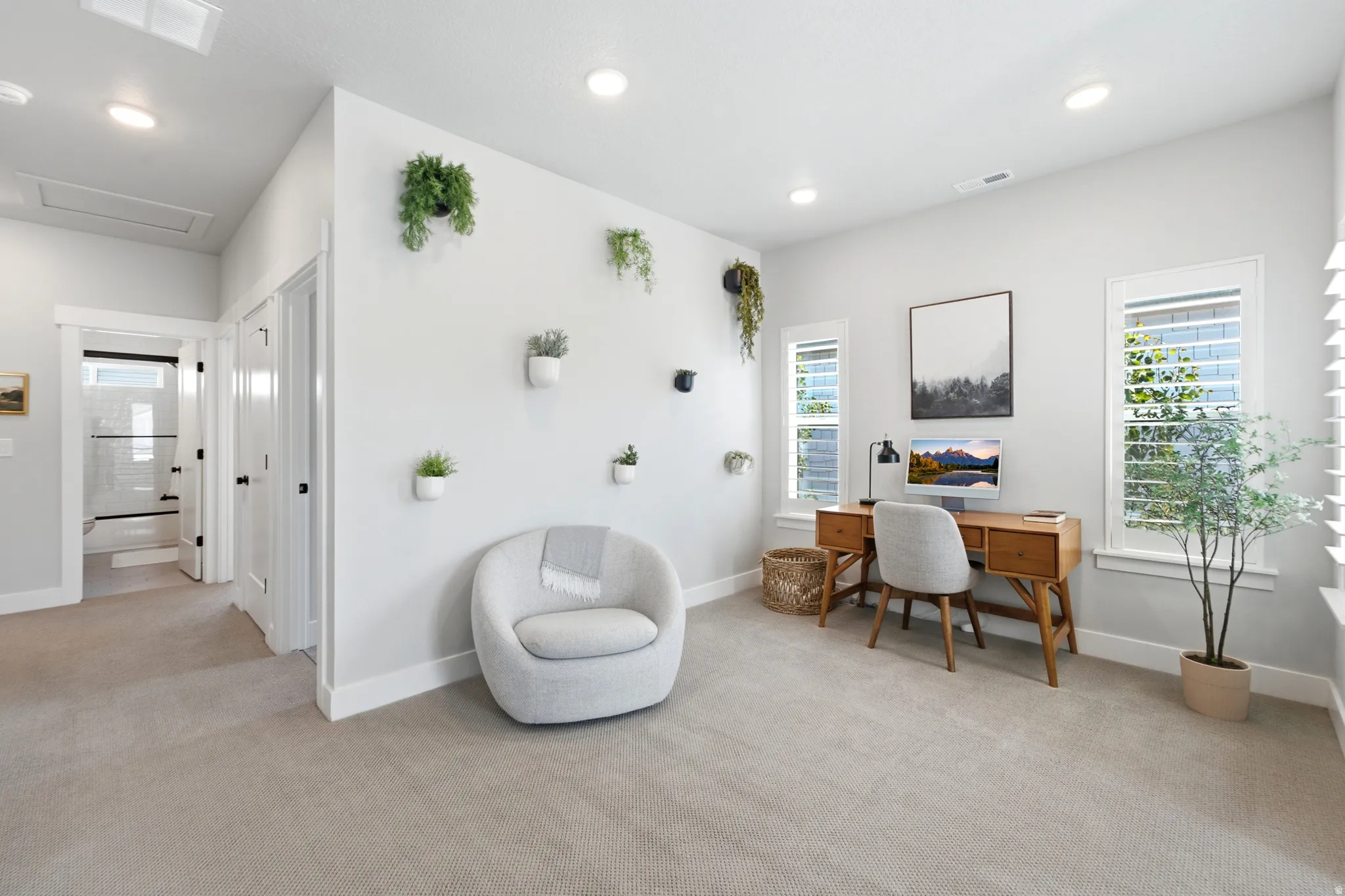 Spacious room with light neutral wall paint and plush carpeting