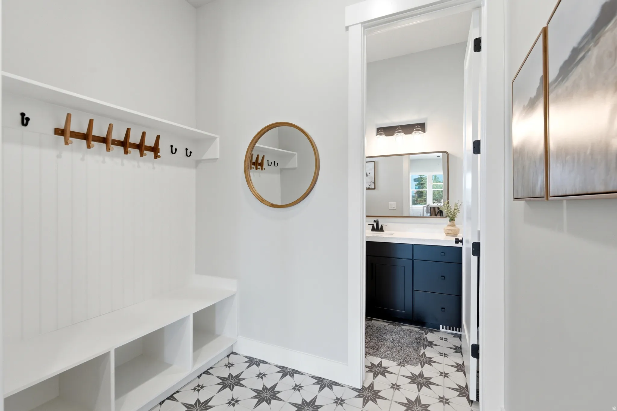 Entry area featuring a built-in bench with integrated shelving and wall-mounted coat hooks