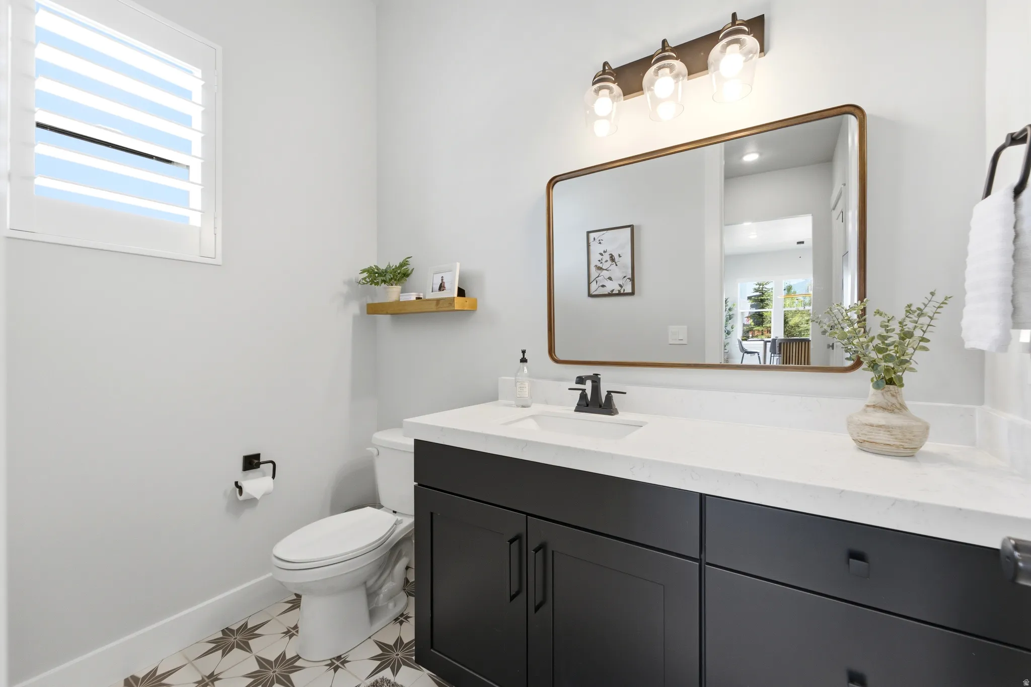 Bathroom featuring a dark wood-finish vanity with a white countertop and integrated sink