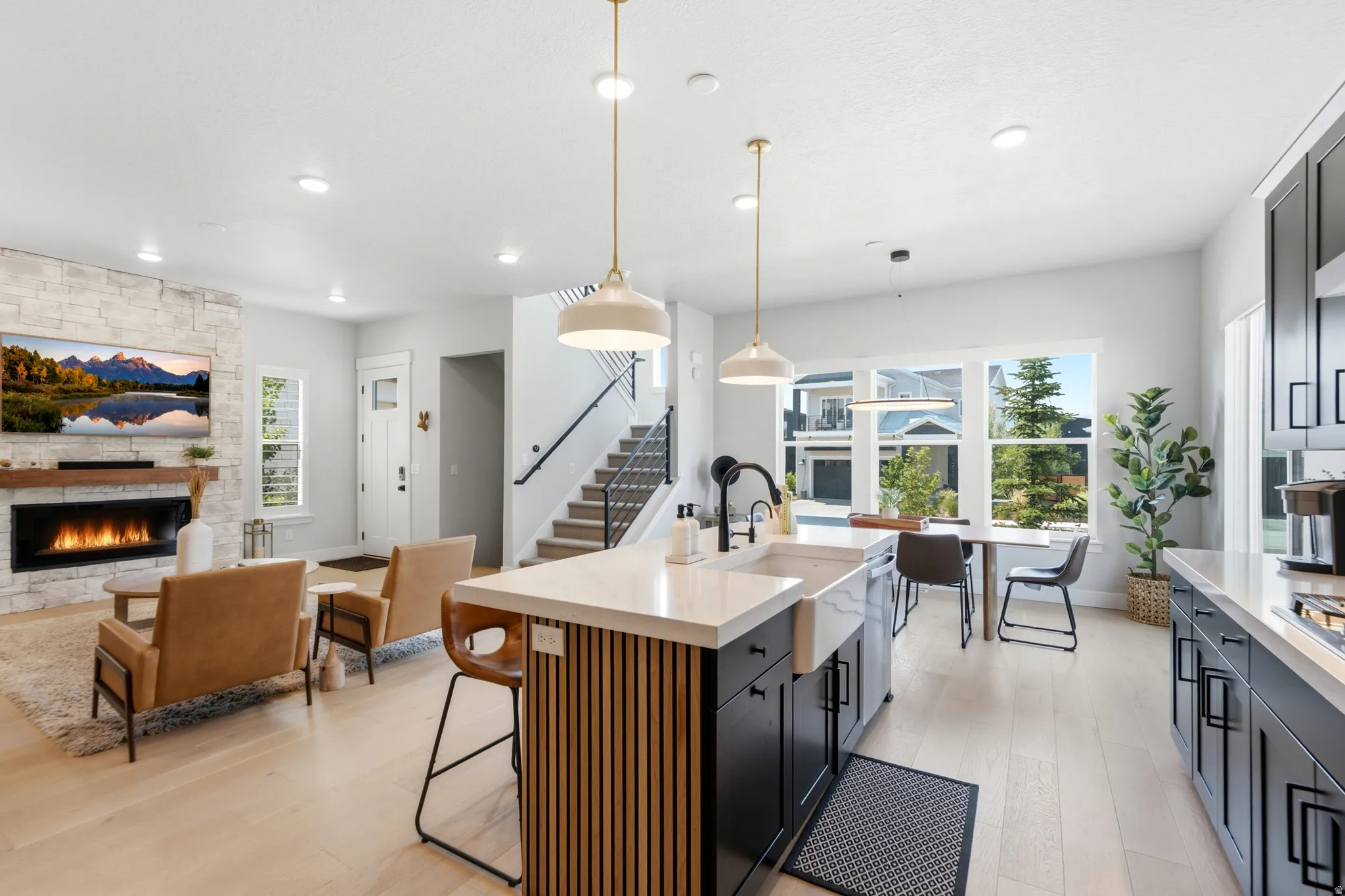 Open-concept living space with light wood-finish flooring