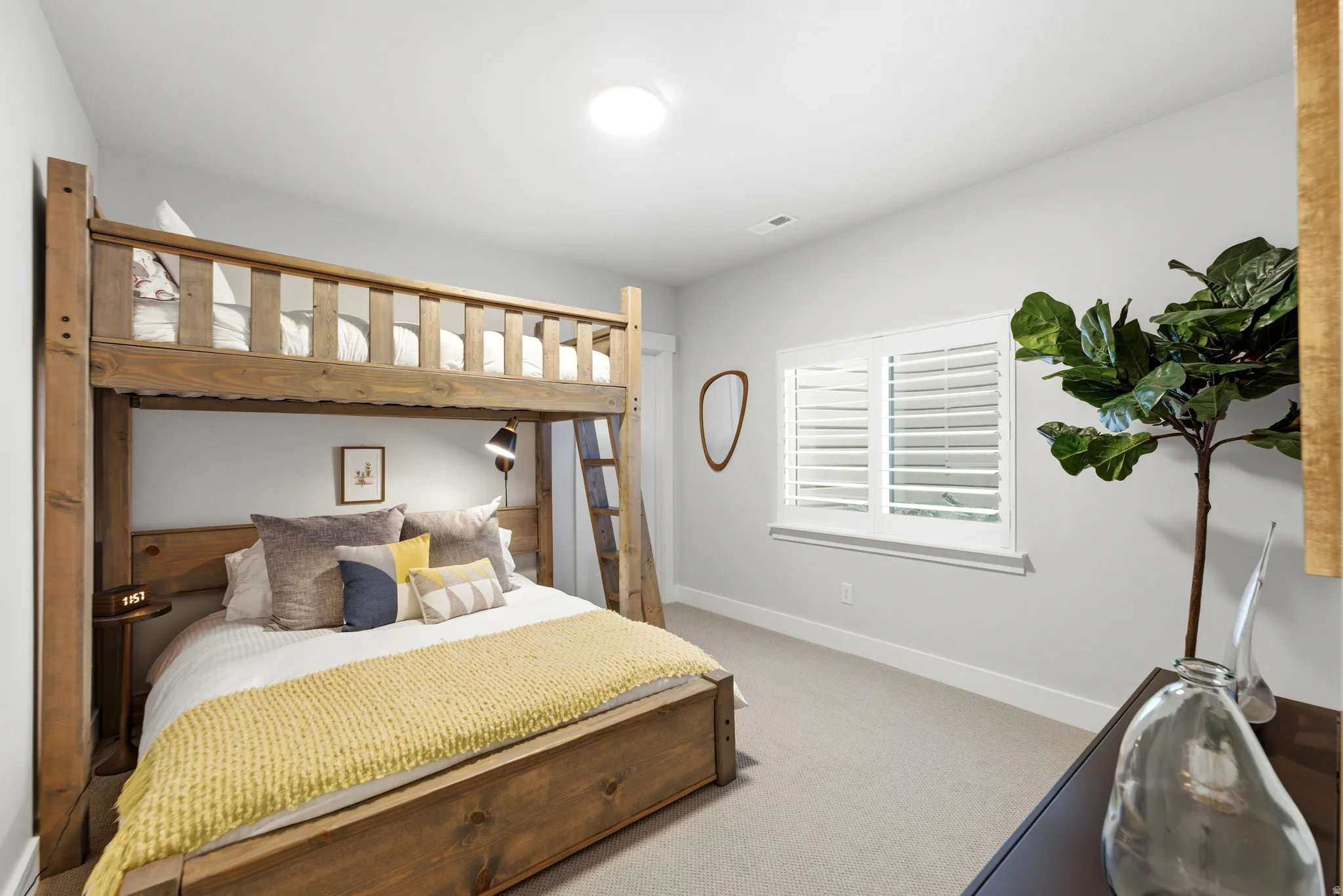 Carpeted bedroom with light gray walls and white trim