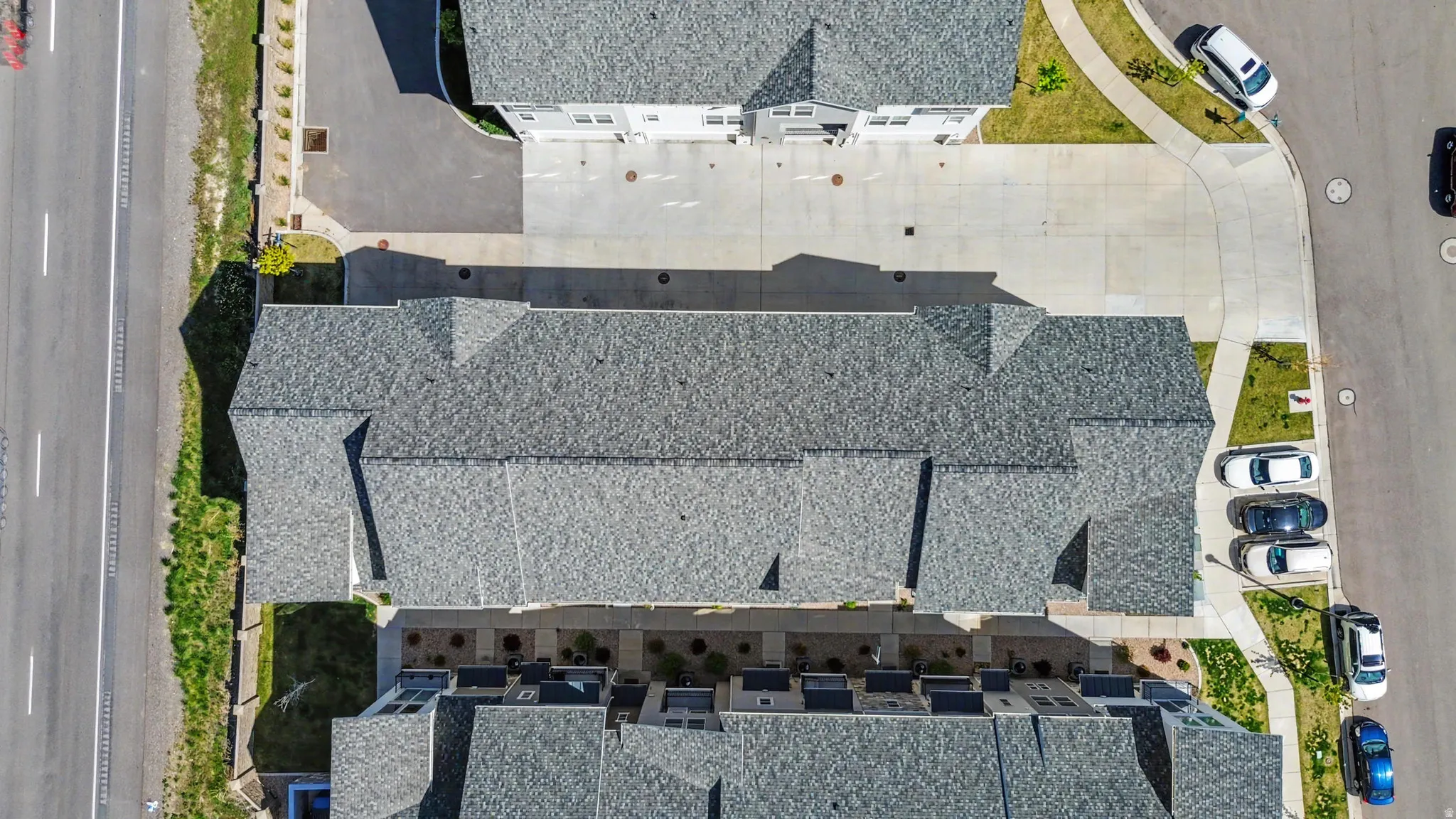 Aerial perspective showcasing a complex of grey-shingled rooftops