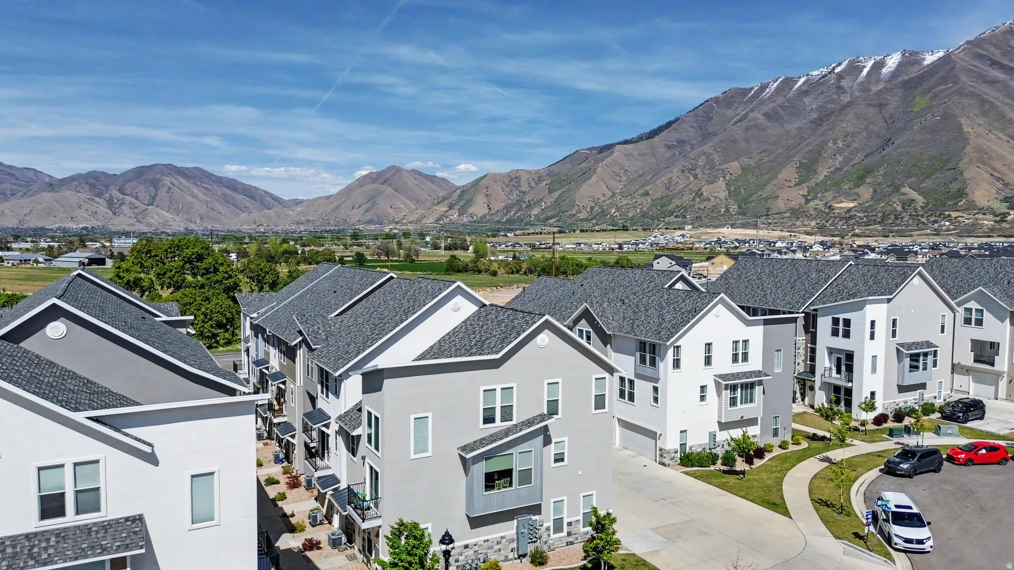 Modern multi-story residences featuring contemporary architecture with stucco and stone accents