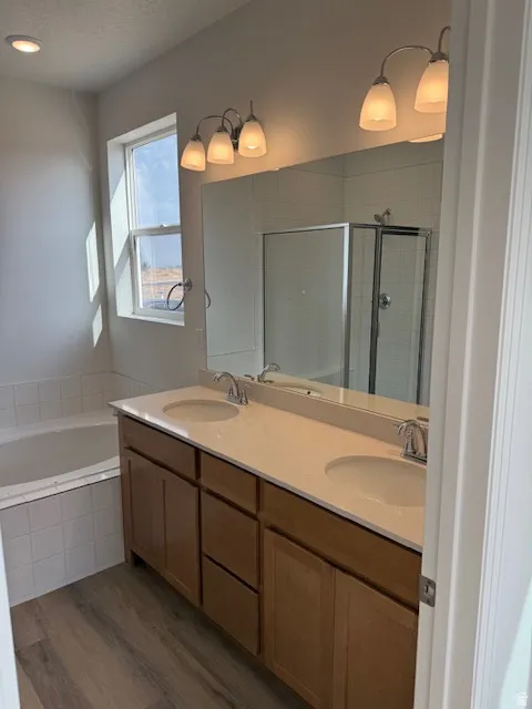 Primary ensuite bath. Double vanity with undermount sinks and light-colored countertops