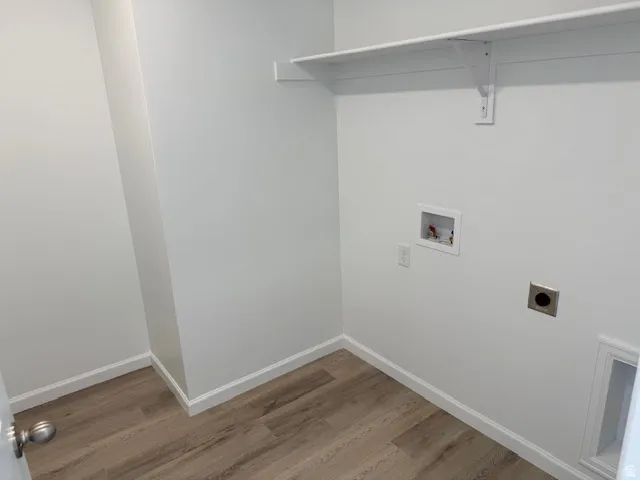 Integrated shelving with support bracket, LVT flooring, and white wall finishes