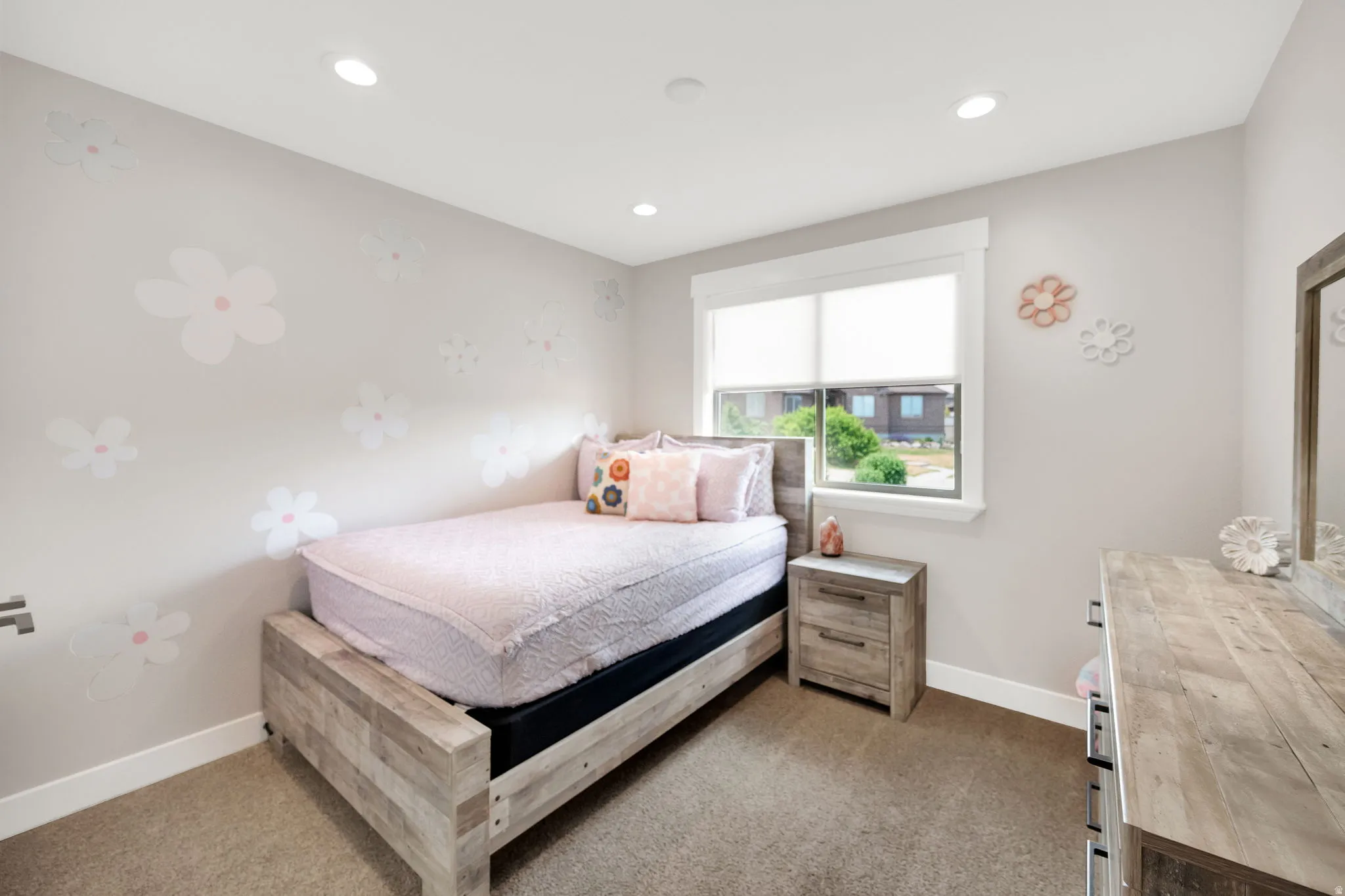 Carpeted room featuring a window with white trim, recessed lighting, and a wood-finish bed frame