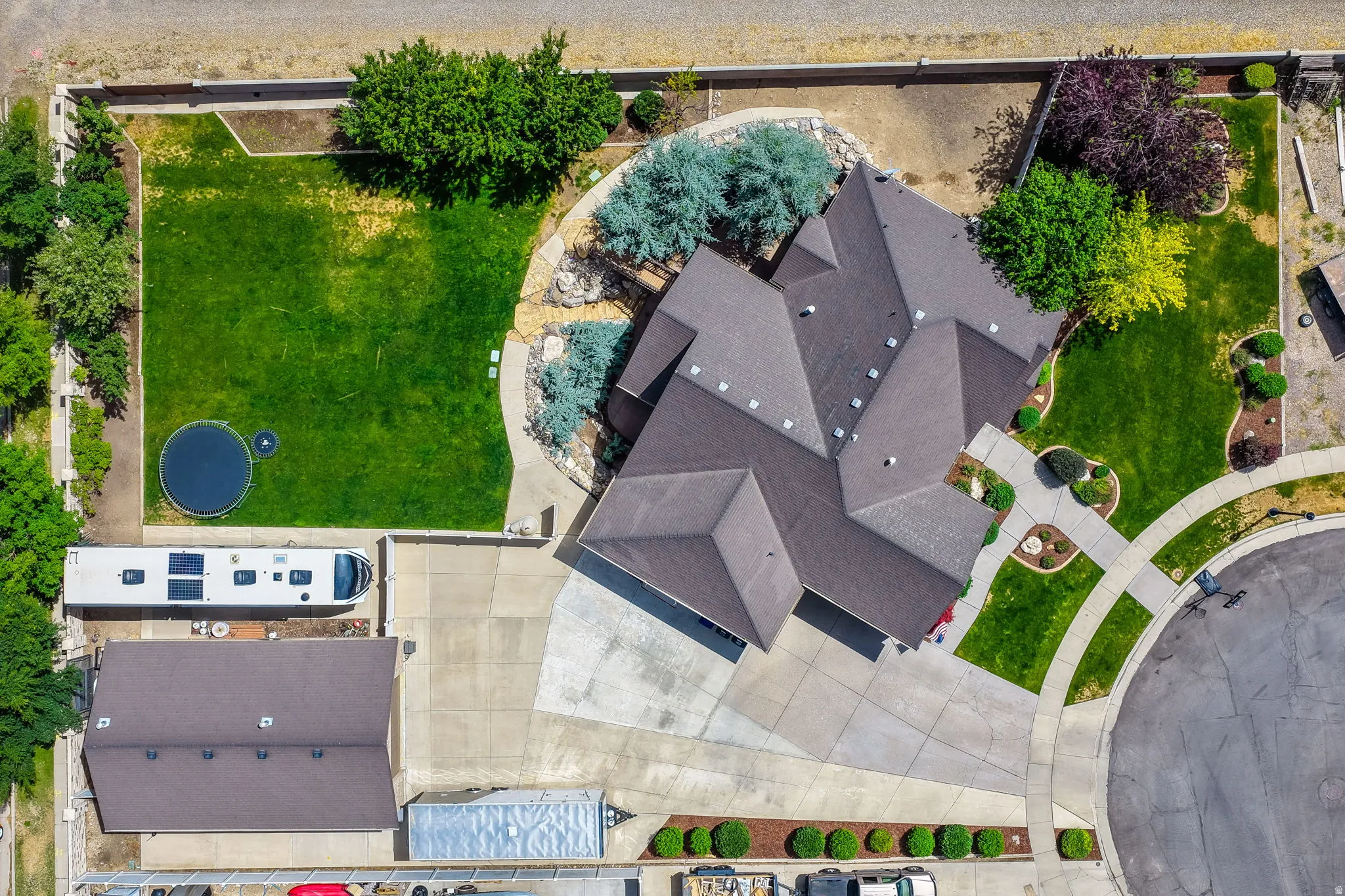 Ariel view of driveway, detached garage and home.