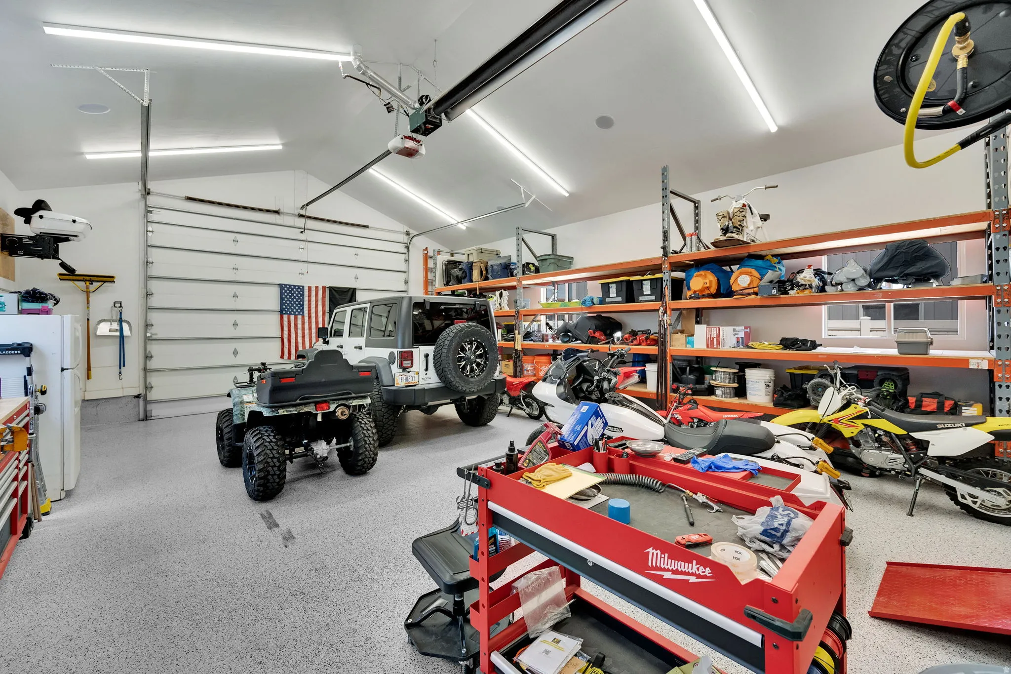 Detached spacious garage featuring epoxy finished floors, 2 overhead doors, 220v/50amp power and heated.