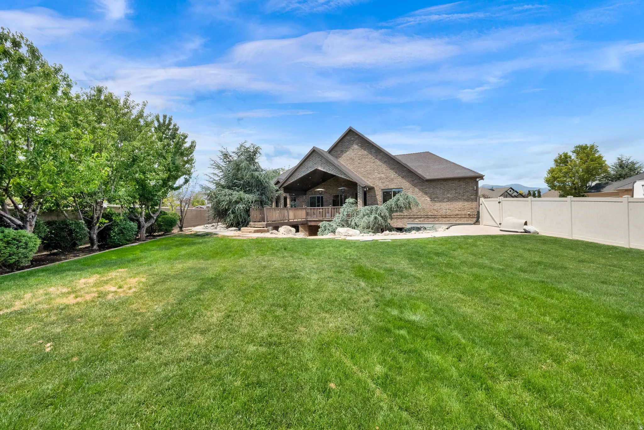 View of the back of the home in the backyard.