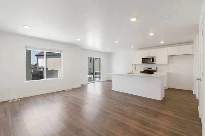 Open-concept living space featuring wood-finish flooring and recessed lighting