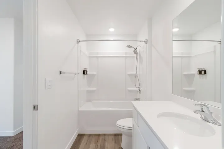 Full bathroom featuring a white tub and shower combination with a curved shower rod