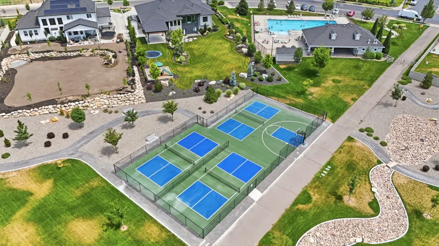 Community recreation area with multiple pickleball courts, a basketball court.