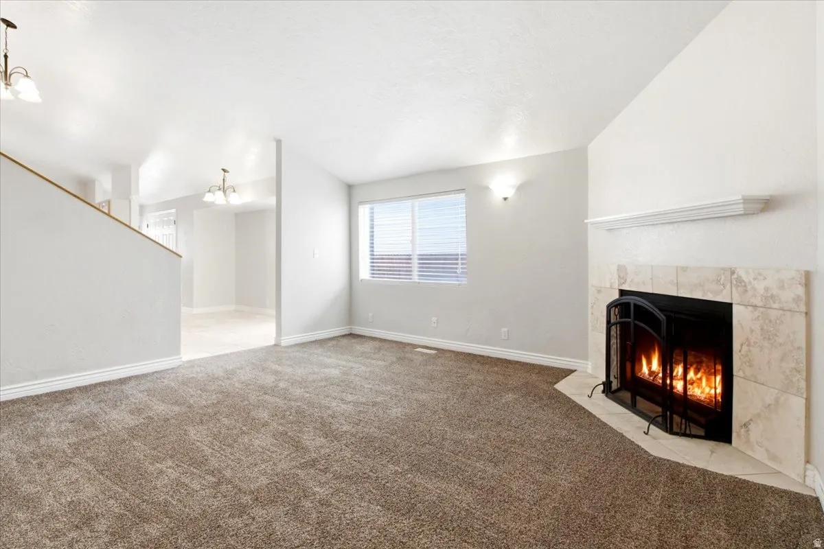 Living area featuring a corner fireplace with a tile surround and mantel