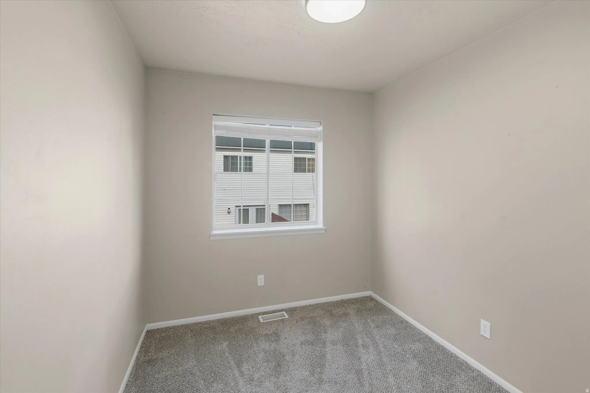 Neutral-toned interior with soft gray carpeting