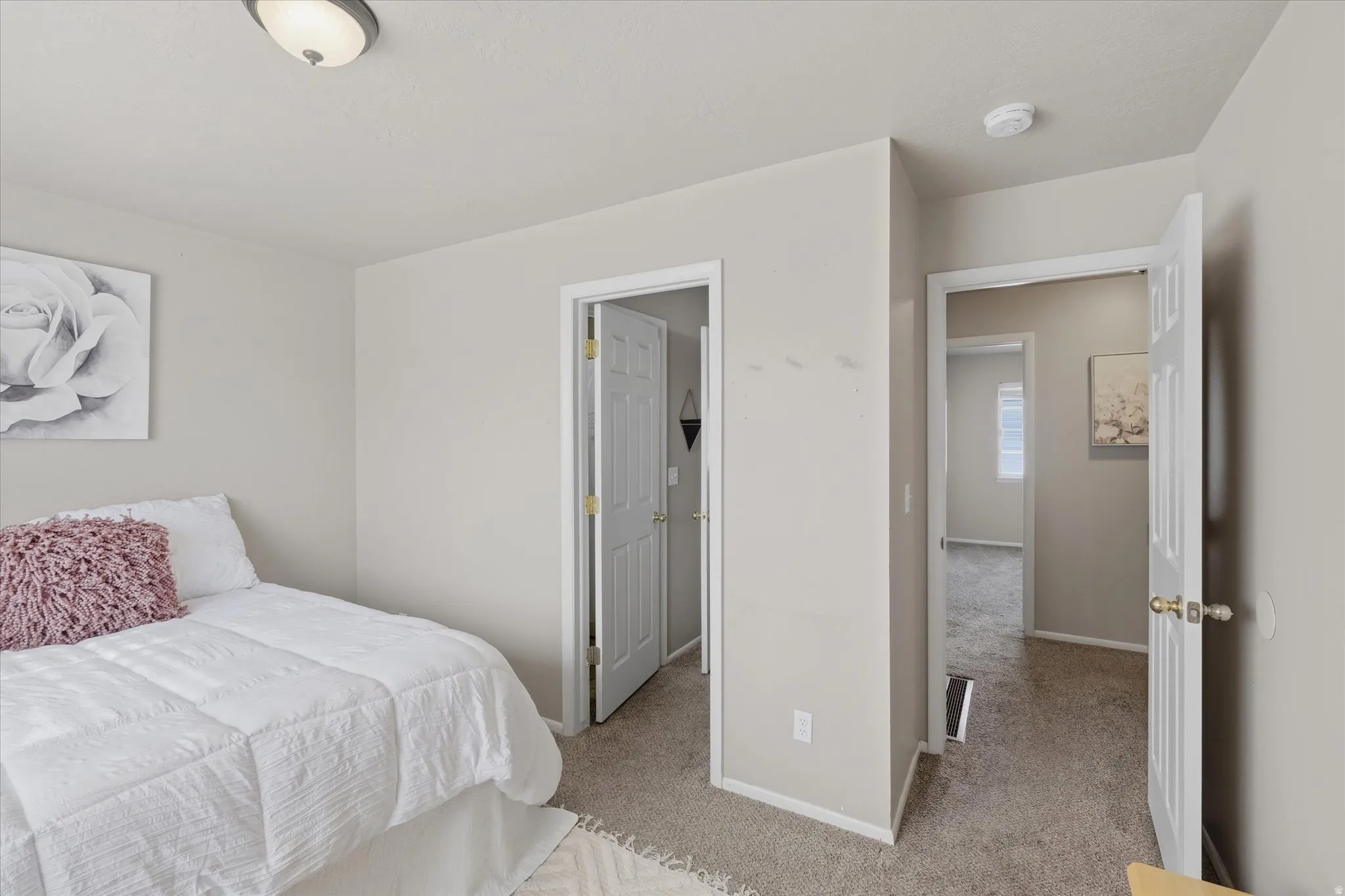 Carpeted room with light gray walls and white trim