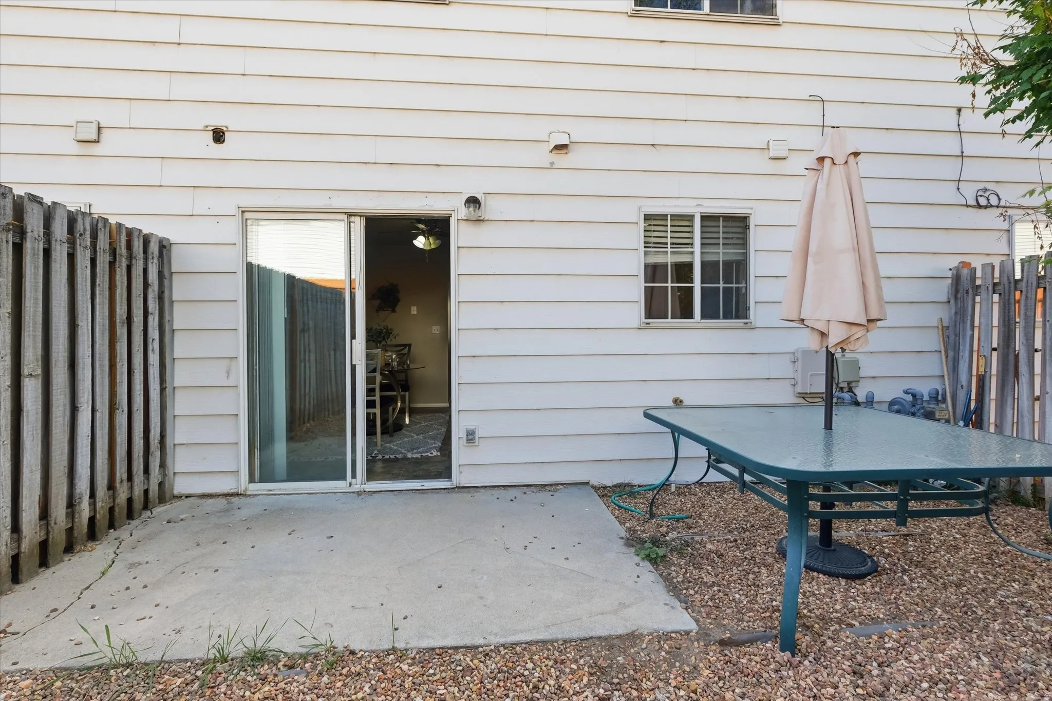Private patio with concrete pad and gravel landscaping
