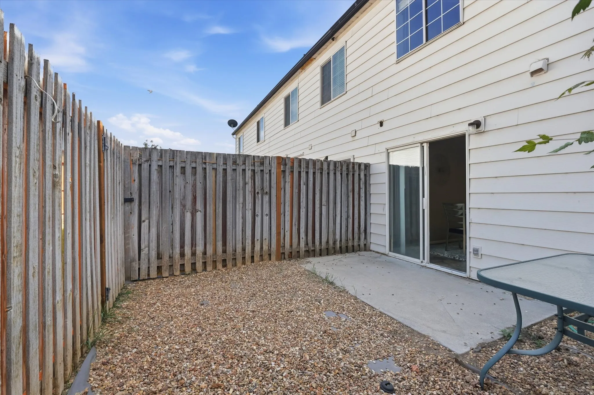 Private outdoor space featuring gravel ground cover and a concrete patio