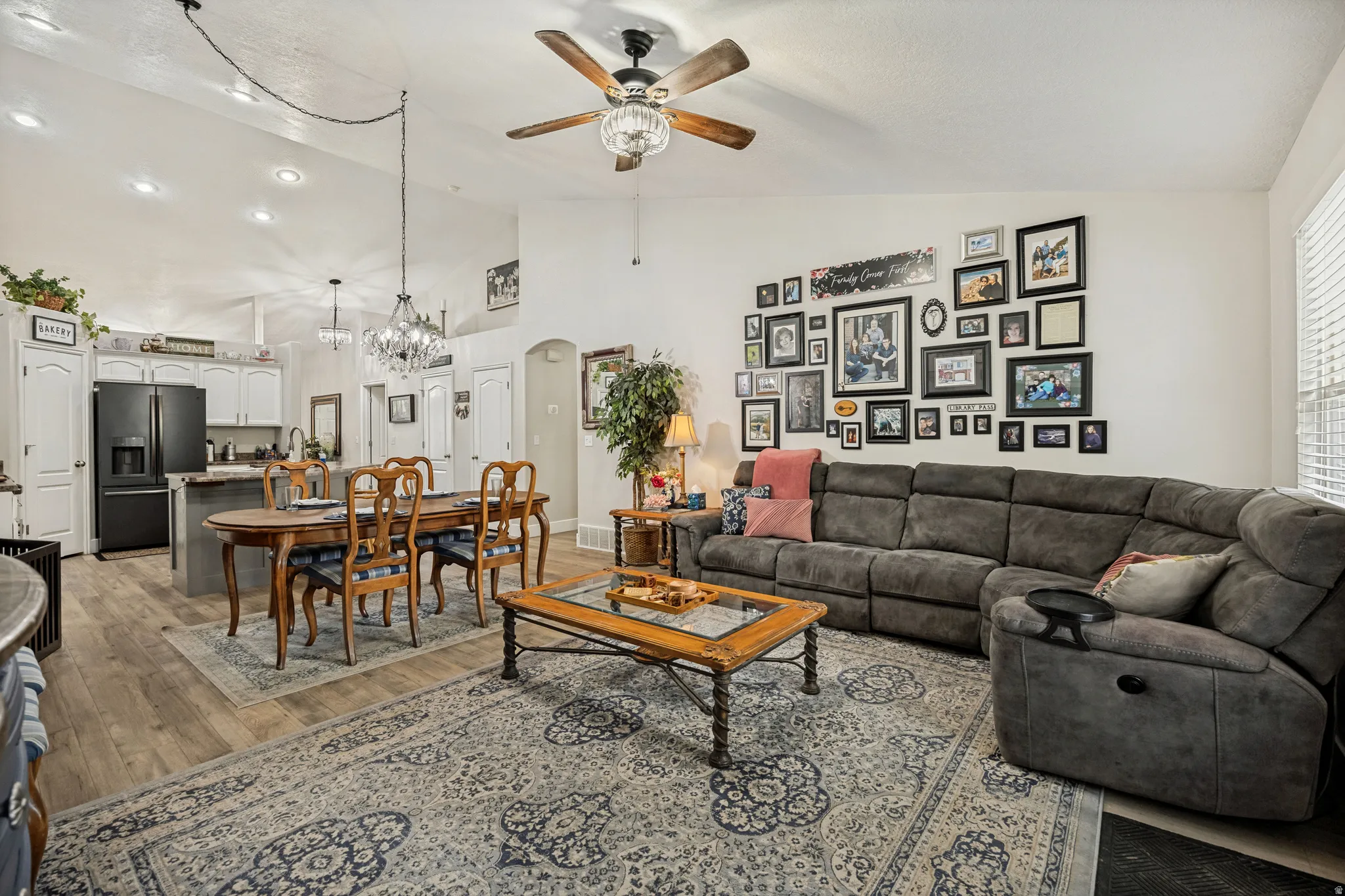 Open-concept living area with vaulted ceilings and wood-finish flooring