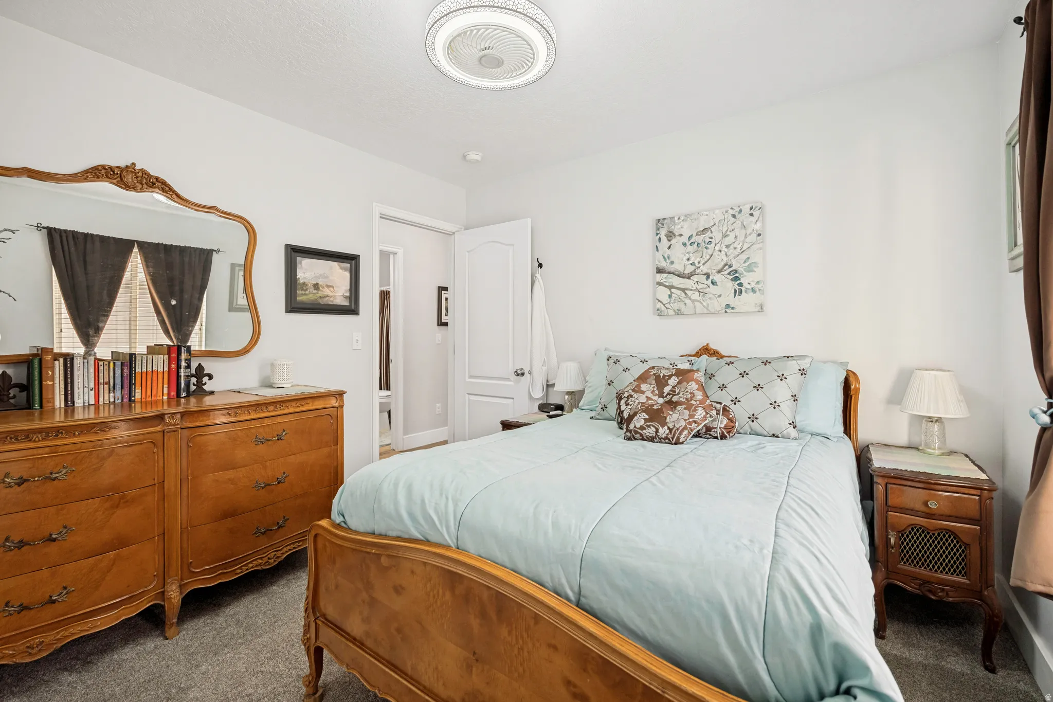 Bedroom featuring light gray walls, gray carpet, white trim, and a white paneled door