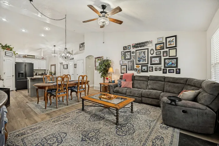 Open-concept living area with vaulted ceilings and wood-finish flooring
