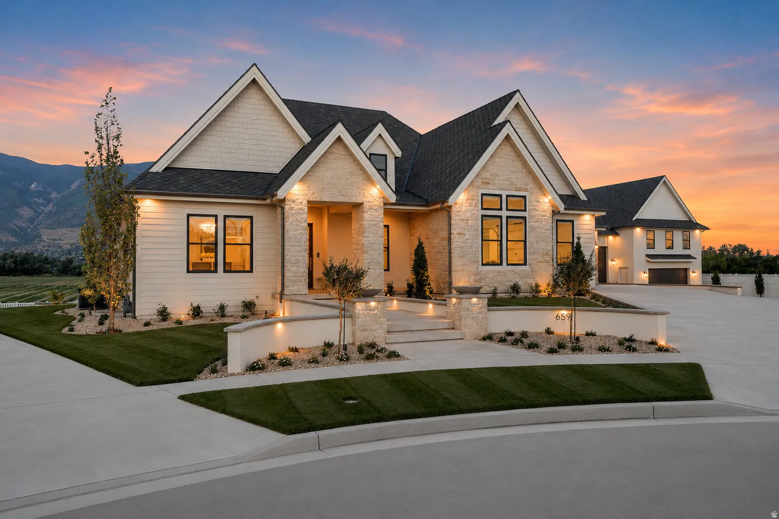 Modern transitional-style exterior featuring a stone facade and horizontal siding