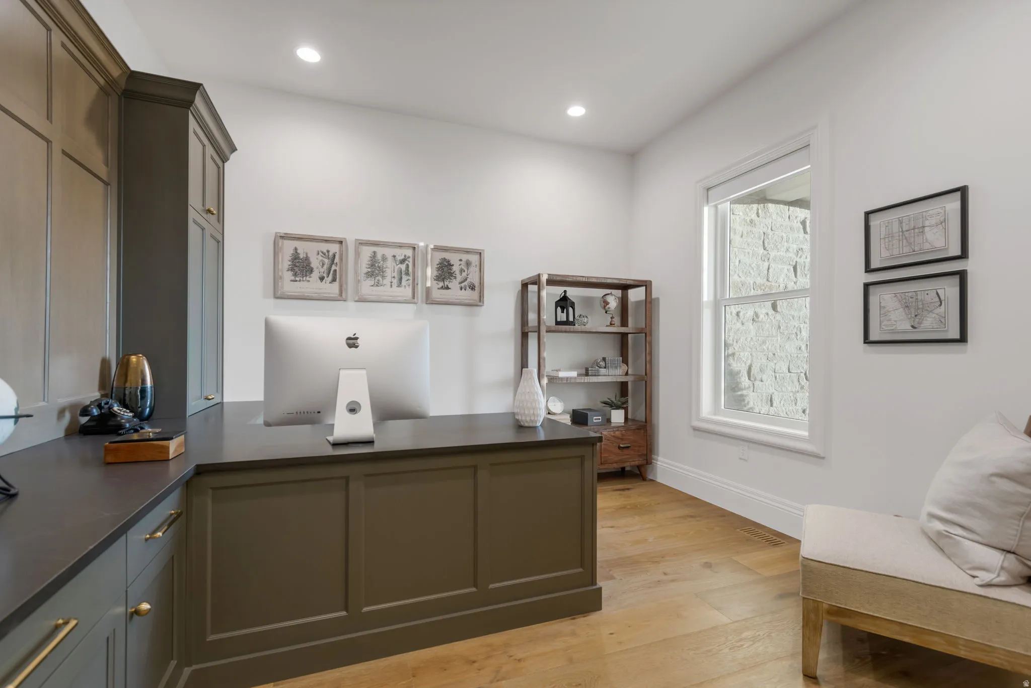Dedicated workspace featuring built-in cabinetry, recessed lighting, and wood-finish flooring
