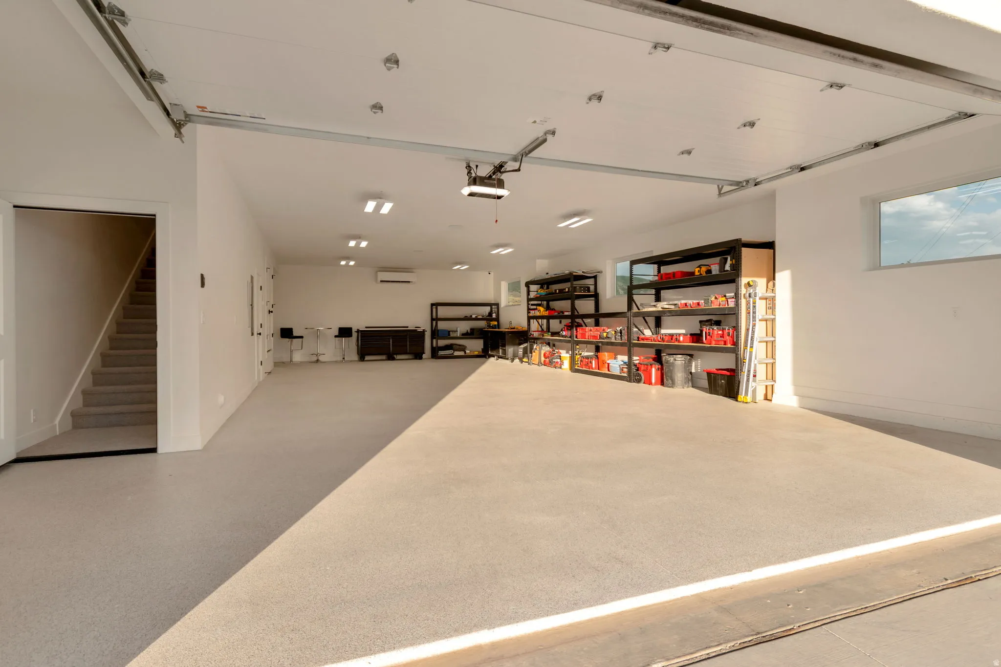 Double wide and deep garage with epoxy flooring, garage sink, 1/2 bath, and fully painted walls/ceiling