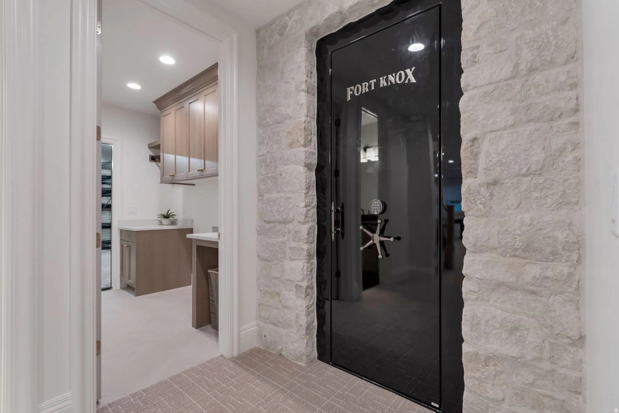 Custom vault door with a stone-clad surround