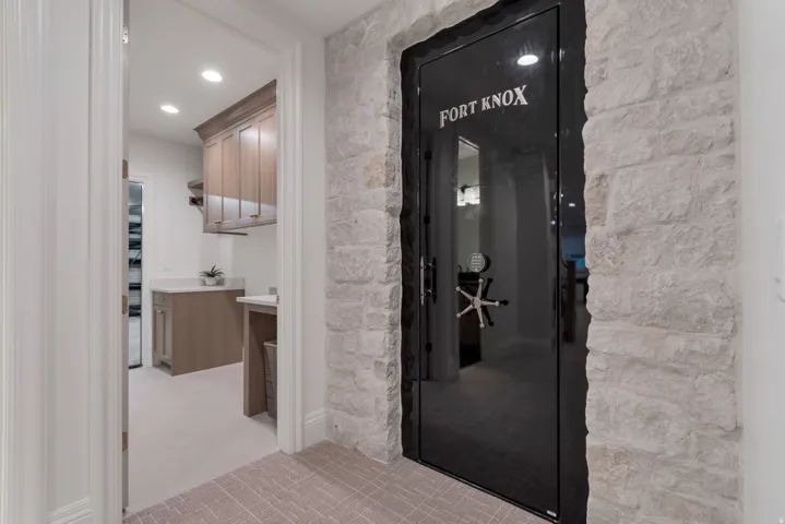 Custom vault door with a stone-clad surround