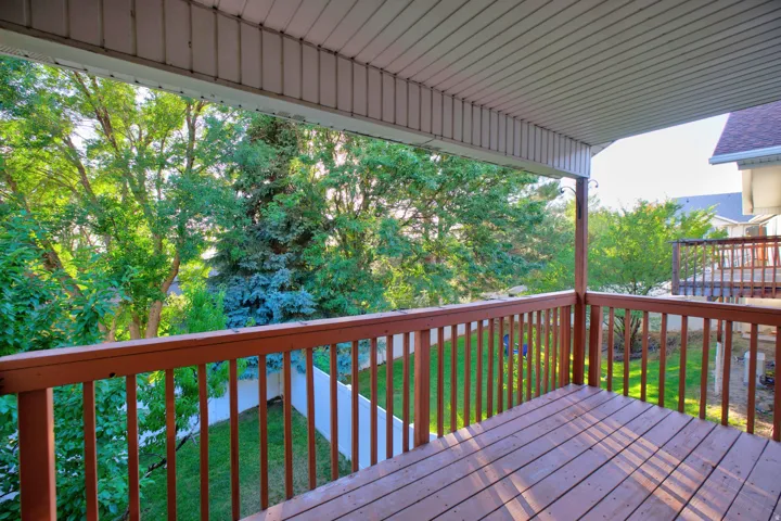 Covered wood deck with slatted railing