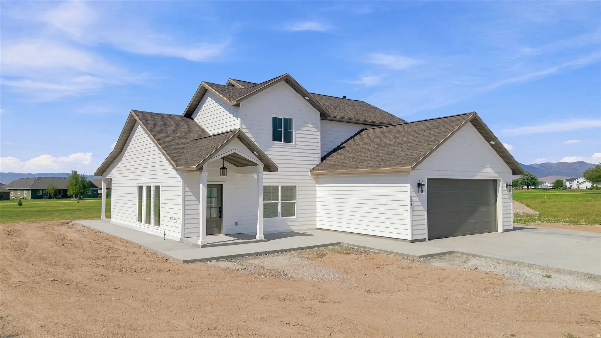 White siding exterior with a dark shingle roof
