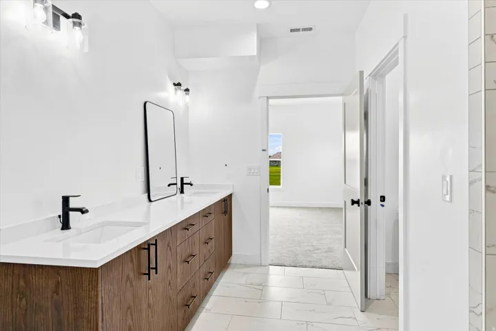 Dual vanity with white countertops and undermount sinks