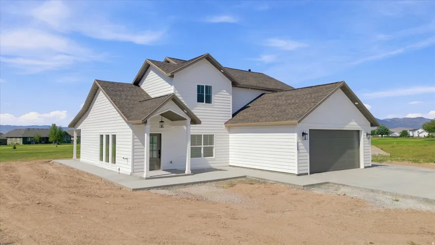 White siding exterior with a dark shingle roof