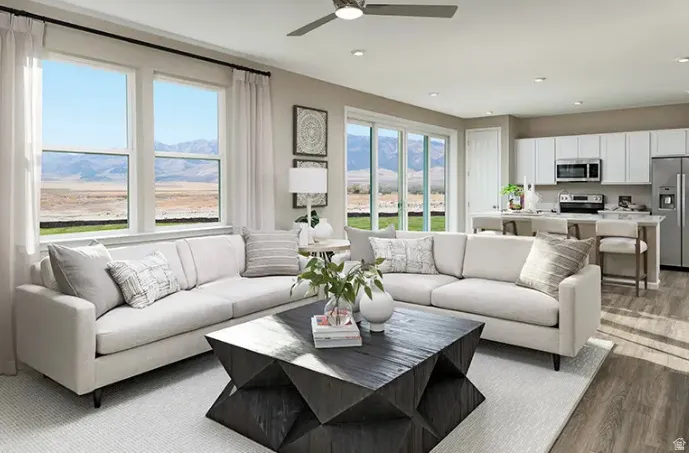 Open-concept living space featuring wood-finish flooring, recessed lighting, and a ceiling fan
