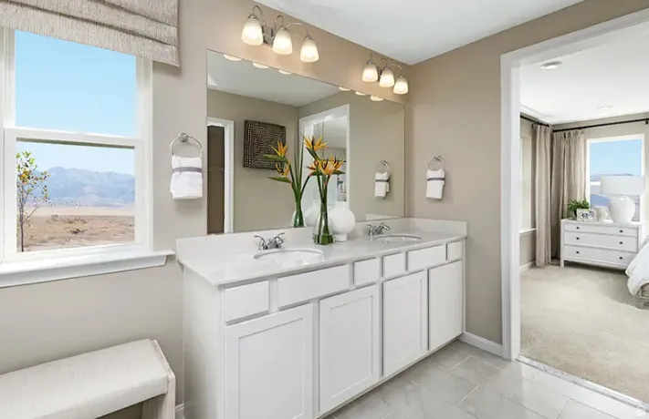 Bathroom with a double vanity featuring a white countertop and white cabinetry