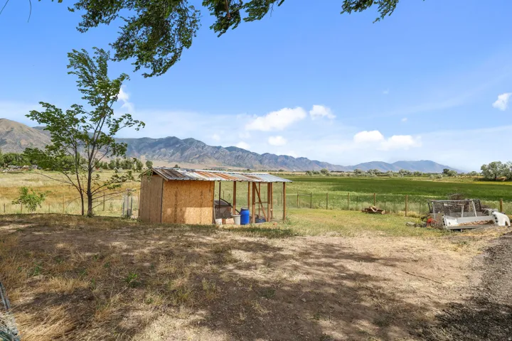 Expansive outdoor area featuring a rustic shed structure with a corrugated metal roof