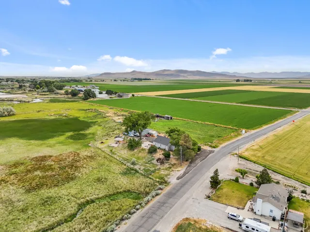 Aerial perspective showcasing multiple residential structures and extensive agricultural fields