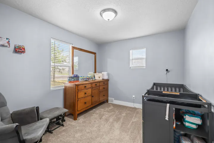 Light gray walls complement the neutral carpet flooring