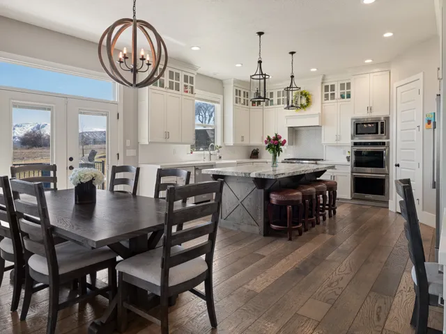 Open-concept kitchen and dining area featuring wide plank wood-finish flooring