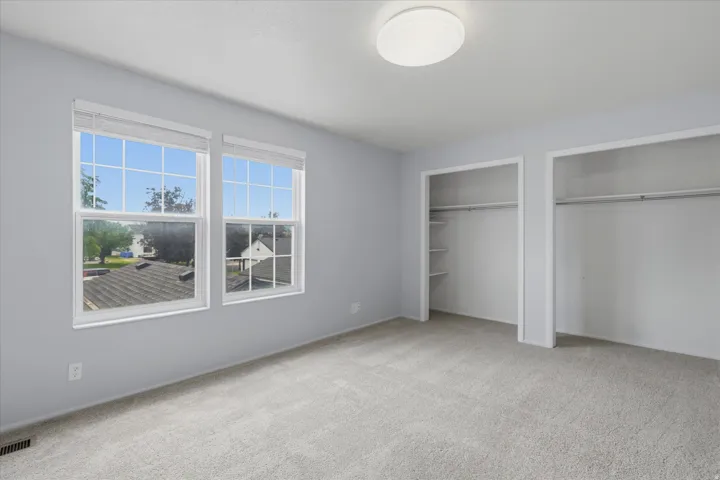 Master bedroom with double closet and ample natural lighting
