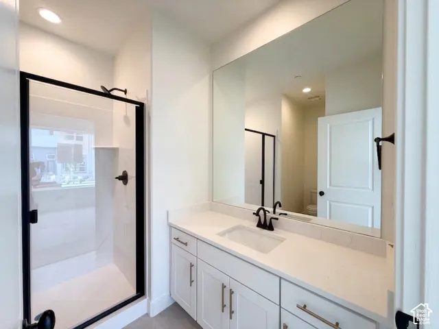 Spacious vanity with an integrated rectangular sink and matte black faucet