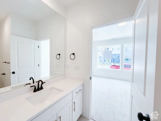 Vanity with integrated sink, matte black faucet, and white countertop