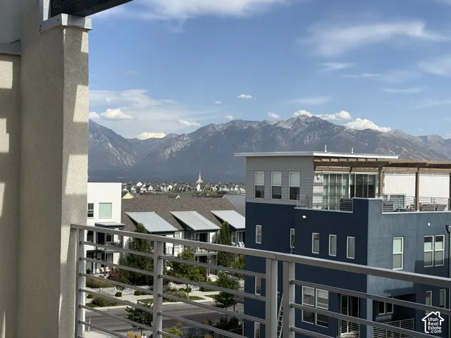 Expansive balcony with metal railings and mountain scenery