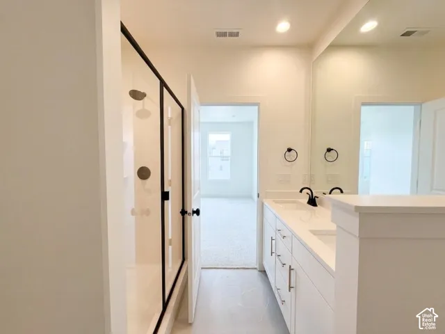 Dual vanity with white cabinetry, quartz countertop, and undermount sinks