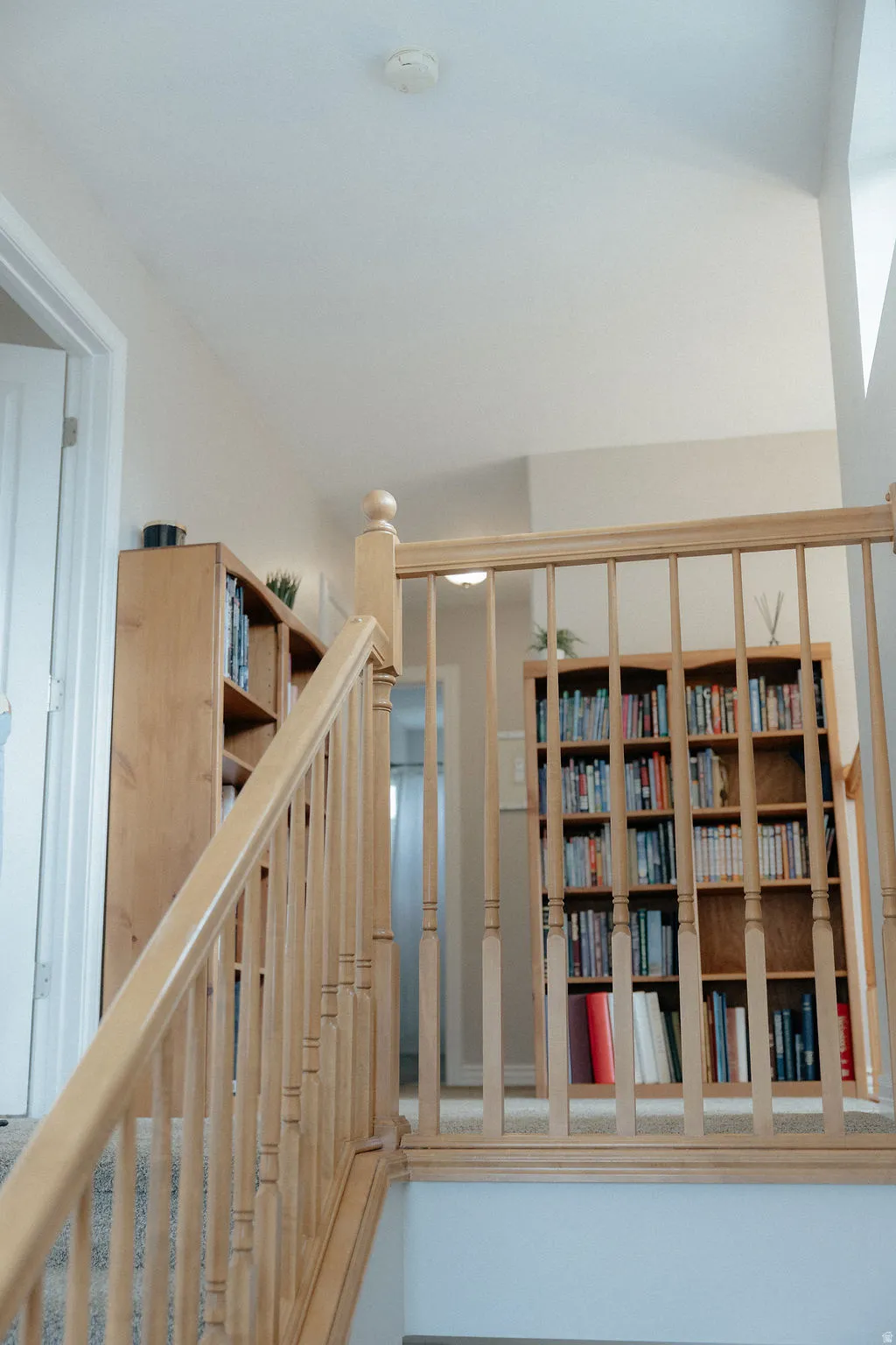 Let's head on upstairs to the bedrooms and bonus room at the top of the stairs. This large landing at the top of the stairs opens up the the chandelier and the front door below.