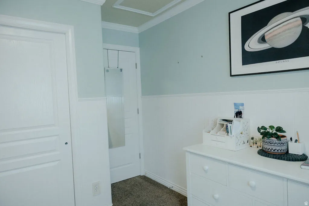 Light blue wall color with white wainscoting and crown molding