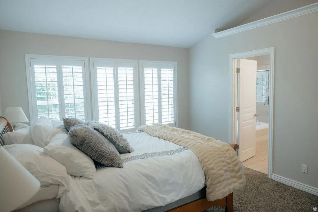 This primary bedroom sits at the top of stairs.  It is spacious, airy and light with large windows, walk in closet and ensuite.
