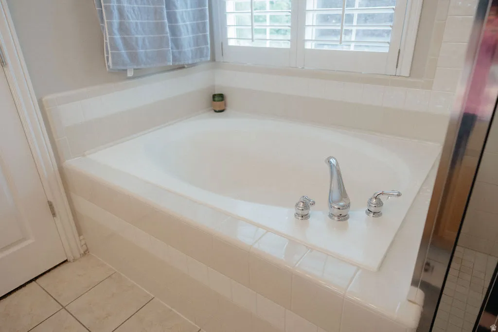 You will love this large built-in soaking tub with chrome fixtures and white tile