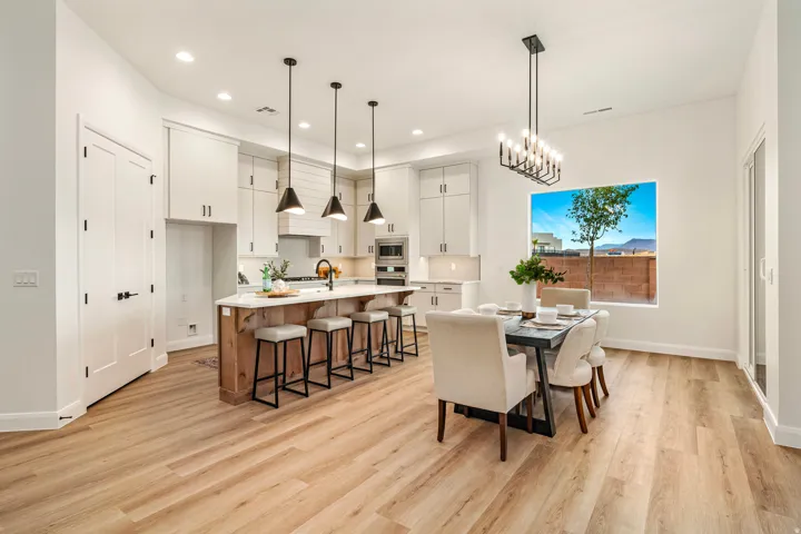 Open-concept kitchen and dining area featuring light wood-finish flooring