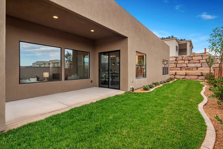 Private rear patio with a concrete surface and recessed lighting